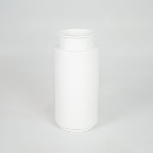 White ceramic storage jar for modern kitchen shelf placement and minimalist indoor decor styling accent piece.