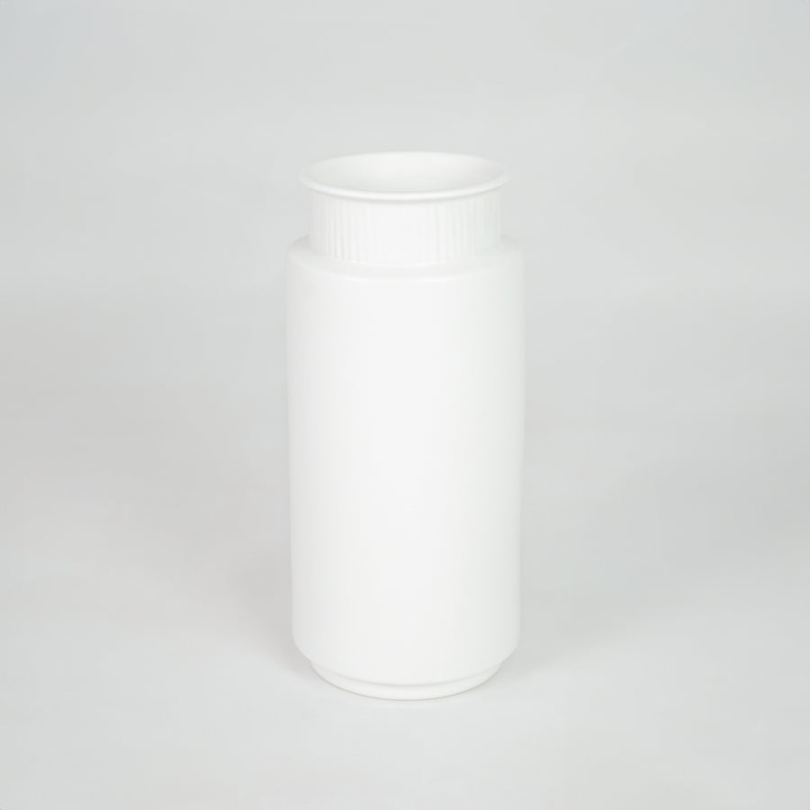 White ceramic storage jar for modern kitchen shelf placement and minimalist indoor decor styling accent piece.