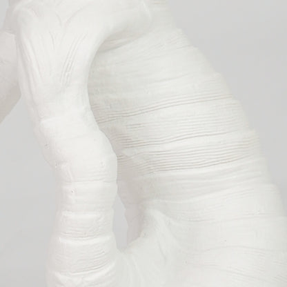 Closeup image of white ceramic abstract vase for modern shelf decor styling with elegant matte textured finish.