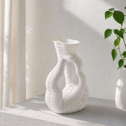 White textured ceramic double vase placed on modern table for elegant contemporary home decor styling.