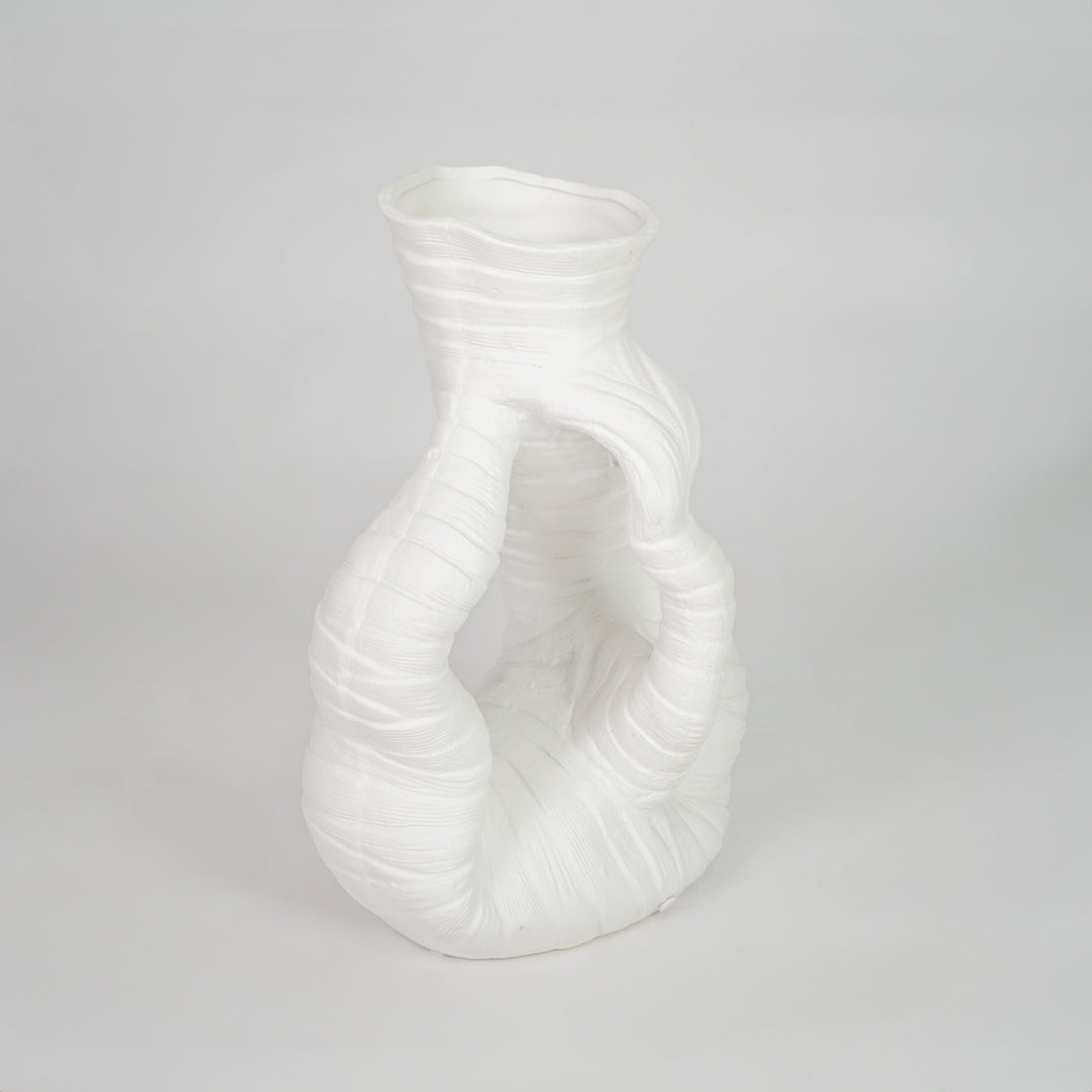 White sculptural ceramic vase for stylish shelf placement and contemporary living room decor styling statement piece.
