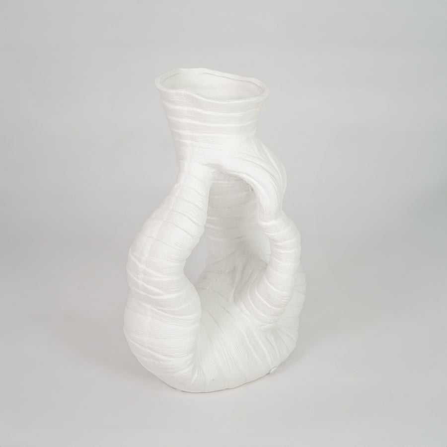 White sculptural ceramic vase for stylish shelf placement and contemporary living room decor styling statement piece.