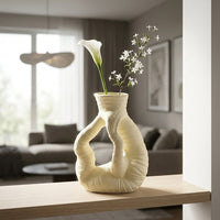 Beige ceramic flower vase with twisted sculpted design for elegant modern home decor placement ideas.