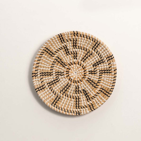 Natural handcrafted woven wall basket with geometric floral pattern for artistic wall styling and contemporary home decor.