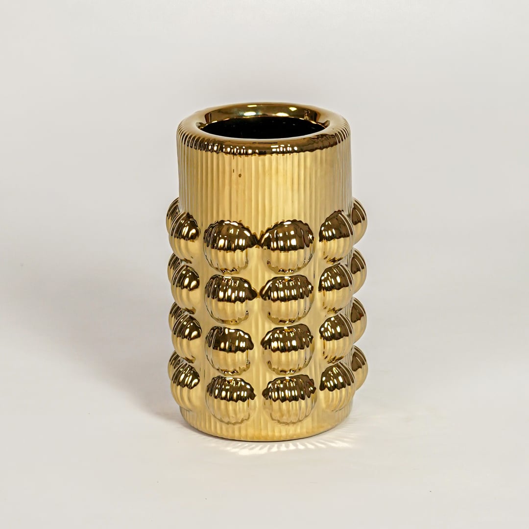 Contemporary gold metal flower vase with raised skull design ideal for entryway table living room shelf decor display.