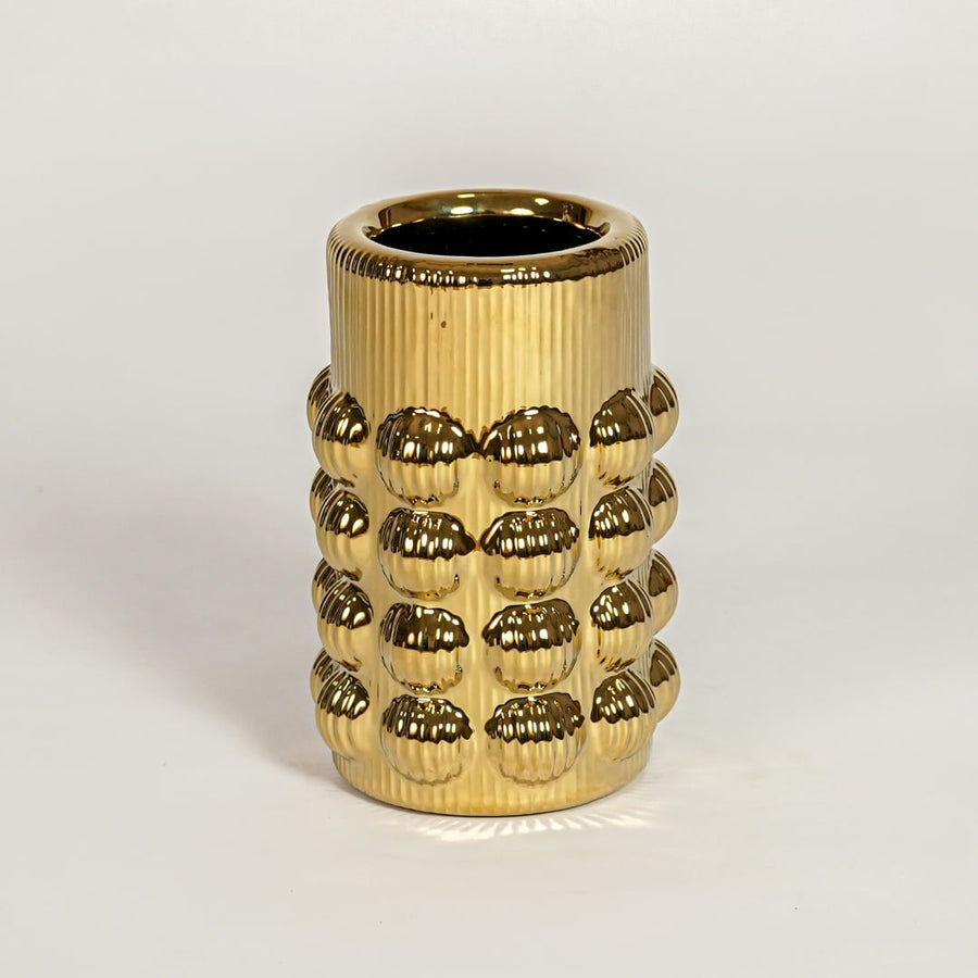 Contemporary gold metal flower vase with raised skull design ideal for entryway table living room shelf decor display.