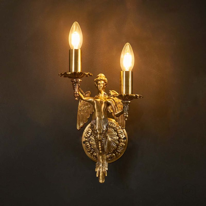 Mermaid cast brass wall sconce Light On Black Background