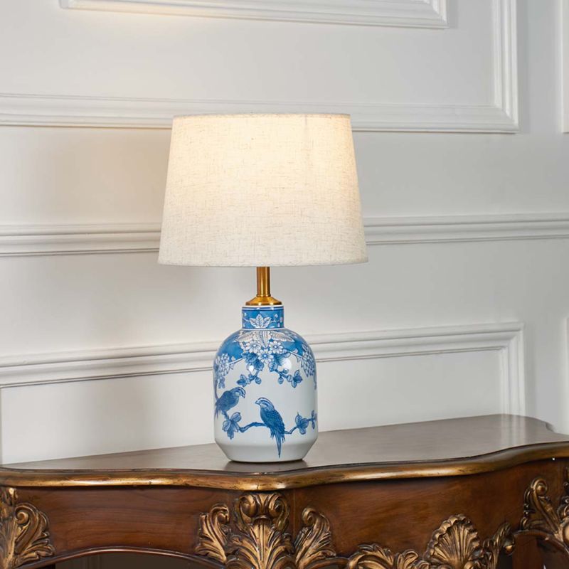 The Beauty of Symbolism White & Blue Ceramic Table Lamp Light On White Background