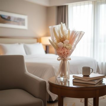Neutral toned dried flower arrangement placed on coffee table near sofa creating calm inviting ambience for modern living room Decor.