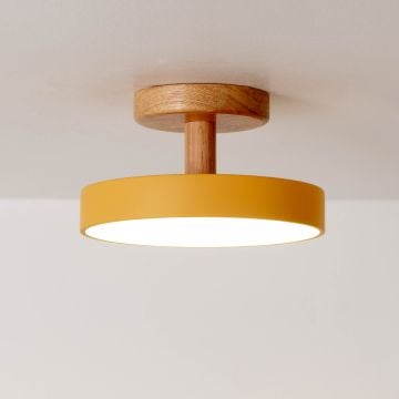 Modern flush mount ceiling light with yellow metal shade and wood base vibrant design for cozy interiors.