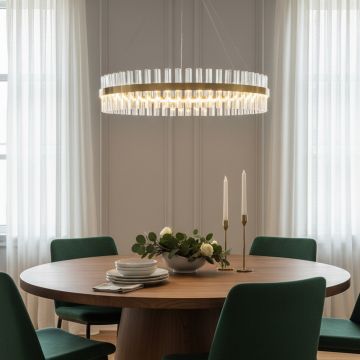 Gold metal chandelier with illuminated crystal rods enhancing a warm contemporary dining space and adding sophisticated ambient lighting to the room.