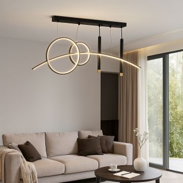 Modern pendant light with glowing circular rings and sleek black frame hanging above beige sofa for living room decor.
