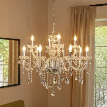 Crystal chandelier with multiple arms and candle lights glowing in elegant living room with window curtains.