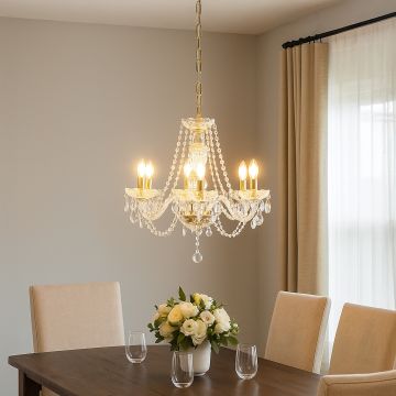 Elegant crystal chandelier with gold accents glowing warmly above dining table for luxurious home decor.