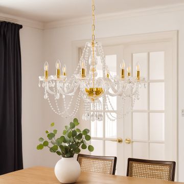 Elegant crystal chandelier with gold accents hanging above dining table for luxury home lighting decor.