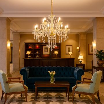 Crystal chandelier with gold detailing glowing in luxury hotel lobby interior above sofa and chairs for elegant decor.
