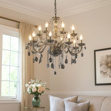 Smoky crystal chandelier with silver accents glowing warmly above sofa in living room for luxury interior decor.