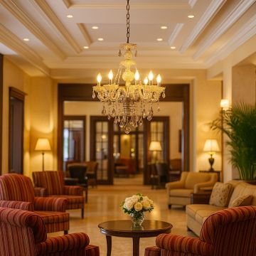 Elegant crystal-chandelier lighting up a luxurious living room with warm ambiance and stylish interior decor.