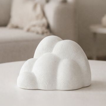 White ceramic abstract cloud sculpture with textured pattern styled on console table for modern decor accent.