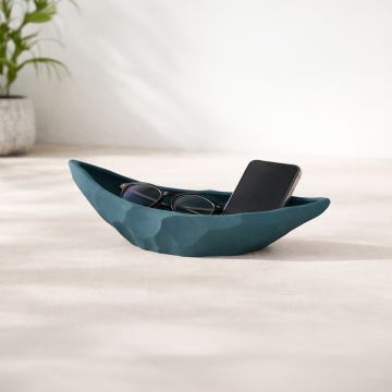 Teal ceramic decorative platter styled on coffee table holding accessories for contemporary home decor setting.