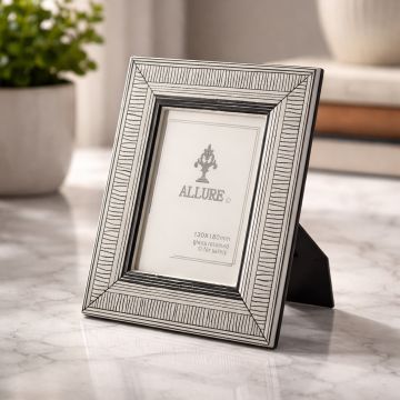 Silver metal photo frame displayed on console table creating elegant and classic interior decor accent.