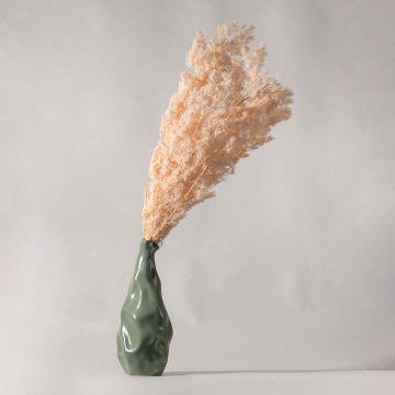 Peach pampas grass styled in modern green ceramic vase for elegant home decor adding soft natural texture to living spaces.