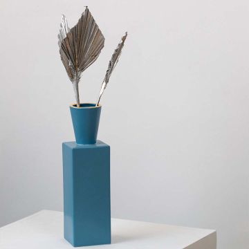 Silver dried palm leaves in modern blue vase styled for boho home decor and table decoration.