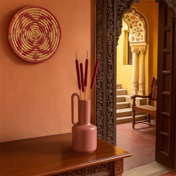 Decorative cattail stems in a modern terracotta vase styled on a wooden console table in a traditional ethnic home interior – natural dried flowers for home decor.