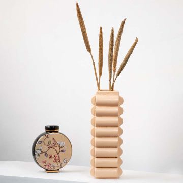 Typha decor arrangement in vase placed on tabletop modern home styling accent.