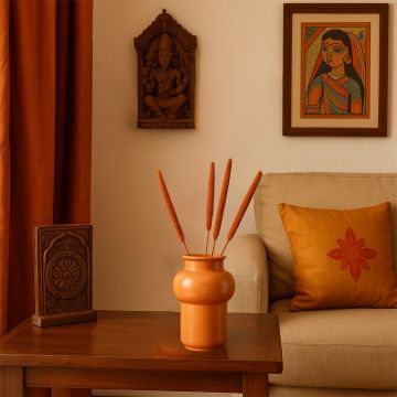 Elegant bulrush stems in a modern white vase styled with artistic decor add natural charm to home interiors.