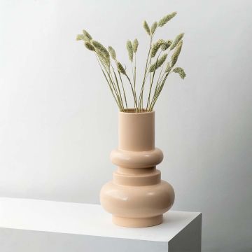 Green lagurus dried bunny tail grass styled in modern beige ceramic vase lifestyle minimal home decor arrangement.