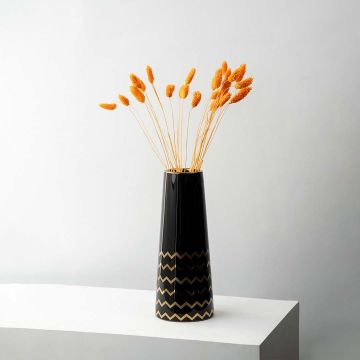 Orange lagurus dried bunny tail grass styled in tall black ceramic vase lifestyle modern home decor arrangement.
