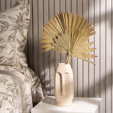 Natural dried palm leaves bunch held in hand perfect for boho home styling and vase decor adding organic earthy charm.