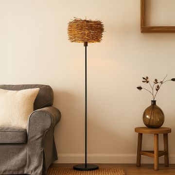 Wicker floor lamp with natural rattan shade placed beside sofa in cozy living room decor.