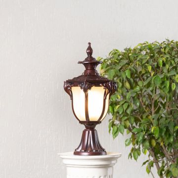 Elegant outdoor brown metal pillar lamp glowing with frosted glass shade perfect for balcony entrance and garden decor.