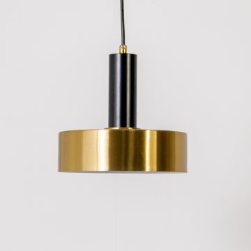 Gold and black metal pendant light on white background with light off highlighting its matte black stem and polished gold cylindrical shade.