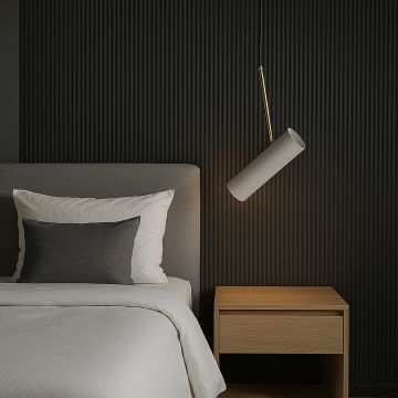 Modern white cylindrical pendant light with golden accent glowing above bed stylish ceiling lamp for luxury bedroom interiors.