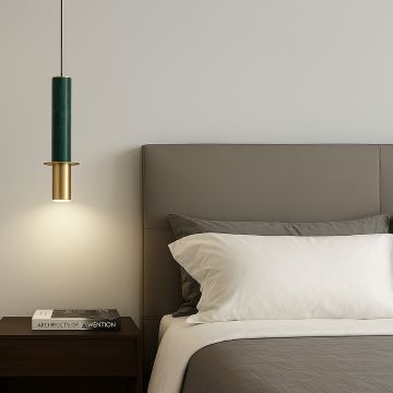 Luxury green marble and brass gold pendant light with cylindrical design adding warm accent lighting to modern bedroom decor.