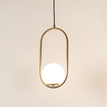 Gold frame pendant light with white globe shade hanging against plain background with light on for modern luxury décor.
