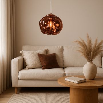 Brown glass bubble pendant light styled in modern living room above beige sofa and wooden coffee table decor.