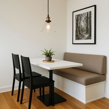 Glass pendant light with metal fitting styled over dining table seating area for modern home lighting decor.