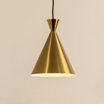 A metal cone pendant light glowing softly against a smooth beige background creating elegant warm lighting and refined minimal interior décor.