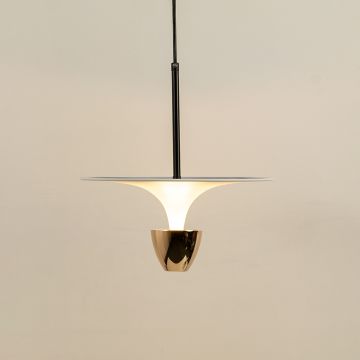 Pendant light with a white flared shade and warm light output creating a gentle ambient glow that enhances the interior with a simple calm and modern decorative presence.