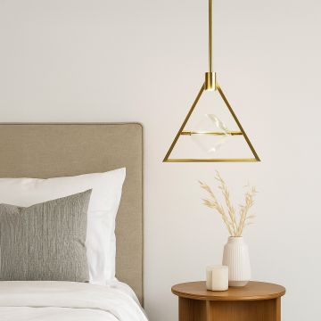 Pendant light with golden triangular frame and crystal center glowing above bedside table in modern bedroom.