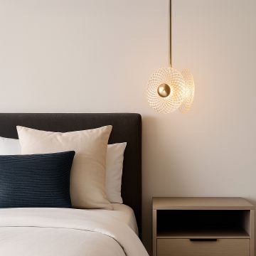 Elegant crystal and gold pendant ceiling light glowing beside modern bed with neutral decor and wooden nightstand
