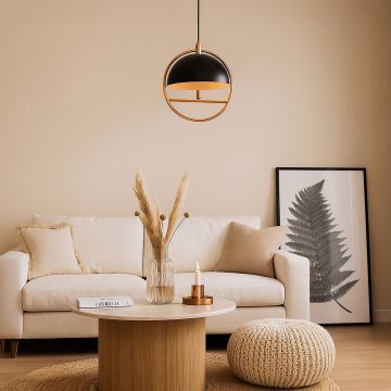 Modern black and gold metal pendant ceiling light hanging in cozy beige living room above sofa and coffee table decor.