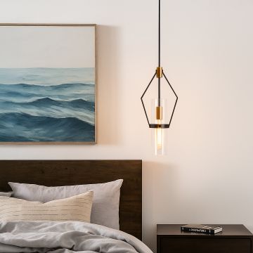 Sleek black and gold pendant light styled in a modern room creating focused warm lighting with clear glass detail.