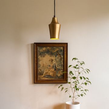 Brass metal hanging light above artwork and plant decor adds warm tone and elegance to wall and corner interiors.