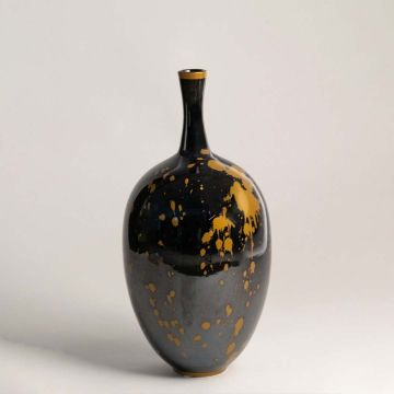 Glossy black ceramic vase with gold splatter design crafted with tall narrow neck for contemporary decor.