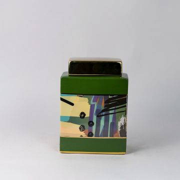 Abstract ceramic jar on white background featuring bold brushstroke patterns in green yellow and purple tones.